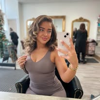 Client with bouncy blow dry curls in the salon